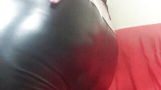 Susi wearing black latex. She is turning around showing asshole